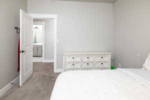 Bedroom with sink and light carpet