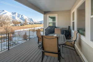 Snow covered deck with a mountain view