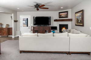 Living room featuring ceiling fan and light wood-type flooring