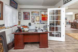 Home office with light hardwood / wood-style floors