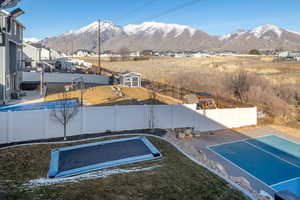 Exterior space with a mountain view and a storage unit