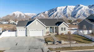 View of front of home with a garage and a mountain view