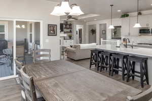 Dining room featuring ceiling fan, sink, and light hardwood / wood-style flooring