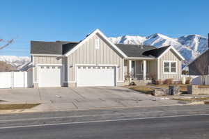 View of front facade with a mountain view and a garage