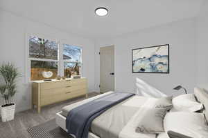 Bedroom featuring carpet floors and baseboards