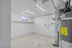 Basement featuring secured water heater