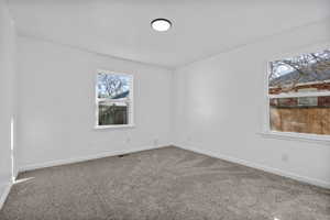 Unfurnished room with carpet