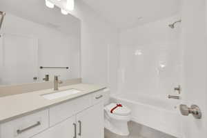 Full bathroom featuring bathing tub / shower combination, wood-type flooring, vanity, and toilet