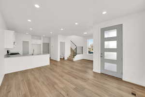 Entryway with sink and light hardwood / wood-style floors