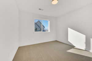 Unfurnished room with carpet flooring