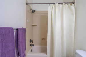 Bathroom with shower / bath combo and toilet