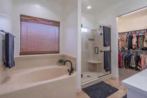 Bathroom with tile patterned floors, shower with separate bathtub, and vanity