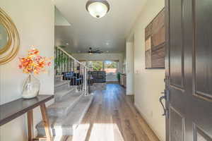 Entrance foyer with wood-type flooring and ceiling fan