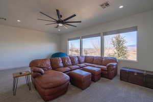 Living room featuring ceiling fan and light colored carpet