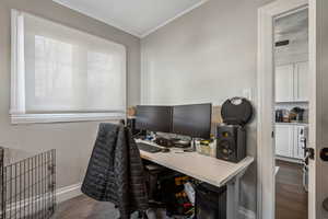 Office space with crown molding and dark hardwood / wood-style floors