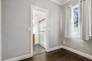 Interior space with dark wood-type flooring and ornamental molding