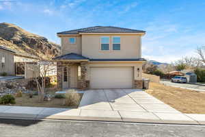 View of front property featuring a mountain view and a garage