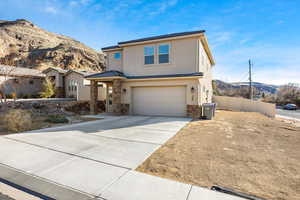 Front facade with a garage and a mountain view