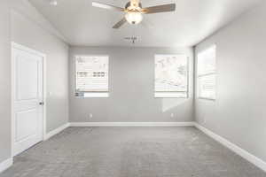 Carpeted empty room with ceiling fan