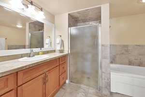 Bathroom with vanity and plus walk in shower