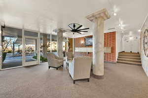 Interior space featuring a textured ceiling, ornate columns, ceiling fan, and track lighting