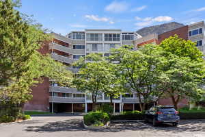 Condo building  with Garage Parking, uncovered parking and a mountain view