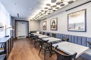 Dining area featuring hardwood / wood-style flooring and ornamental molding