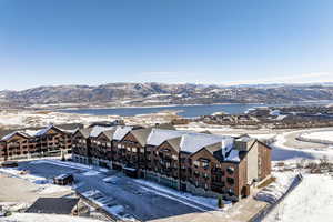 Snowy aerial view with a water and mountain view