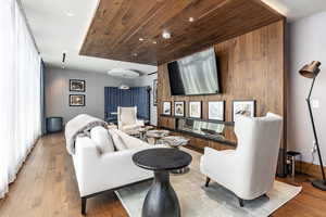 Living room featuring wood ceiling and light hardwood / wood-style flooring