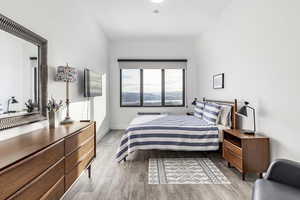 Bedroom with light hardwood / wood-style floors