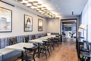 Dining area featuring wood-type flooring and crown molding