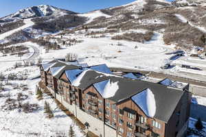 Snowy aerial view featuring a mountain view