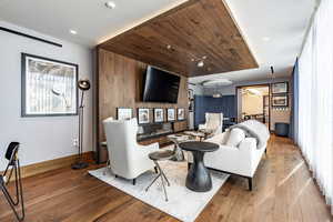 Living room with light hardwood / wood-style floors and wooden ceiling