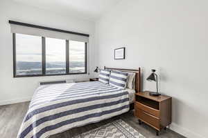 Bedroom with hardwood / wood-style flooring