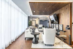 Living room featuring wood ceiling, wood-type flooring, and wood walls