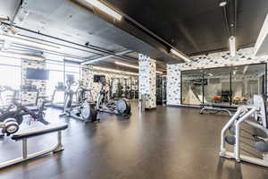 Gym with expansive windows and ornate columns