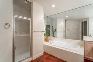 Primary Bathroom with vanity, tile patterned floors, and separate shower and tub