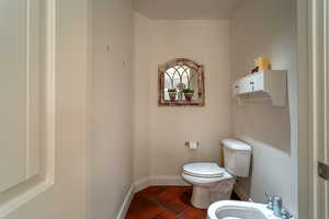 Primary Bathroom featuring a bidet, tile patterned floors, and toilet