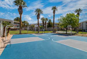 View of basketball court with a yard