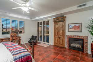 Primary Bedroom with a premium fireplace, access to outside, and ceiling fan