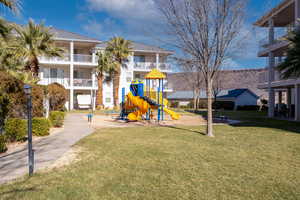 View of jungle gym with a lawn