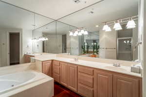 Primary Bathroom featuring vanity, plus walk in shower, and tile patterned flooring