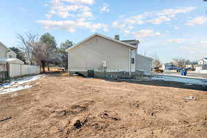 View of side of home with central AC unit