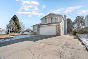 View of property exterior featuring a garage