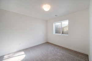 Empty room with carpet flooring