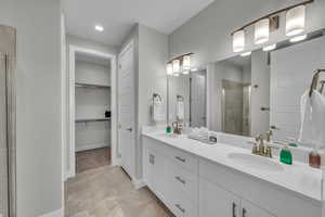 Bathroom featuring an enclosed shower and vanity