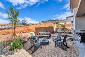 View of patio with an outdoor fire pit