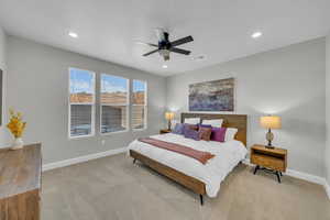 Carpeted bedroom with ceiling fan