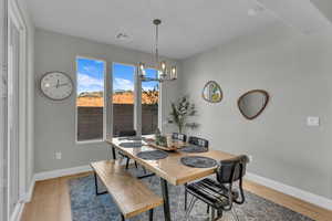 Dining room featuring hardwood / wood-style flooring and an inviting chandelier