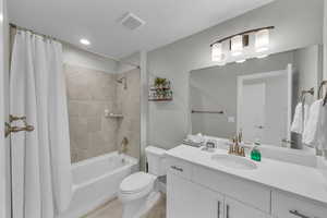 Full bathroom featuring tile patterned flooring, vanity, shower / tub combo, and toilet